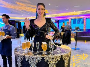 A lady dressed as a walking drinks station